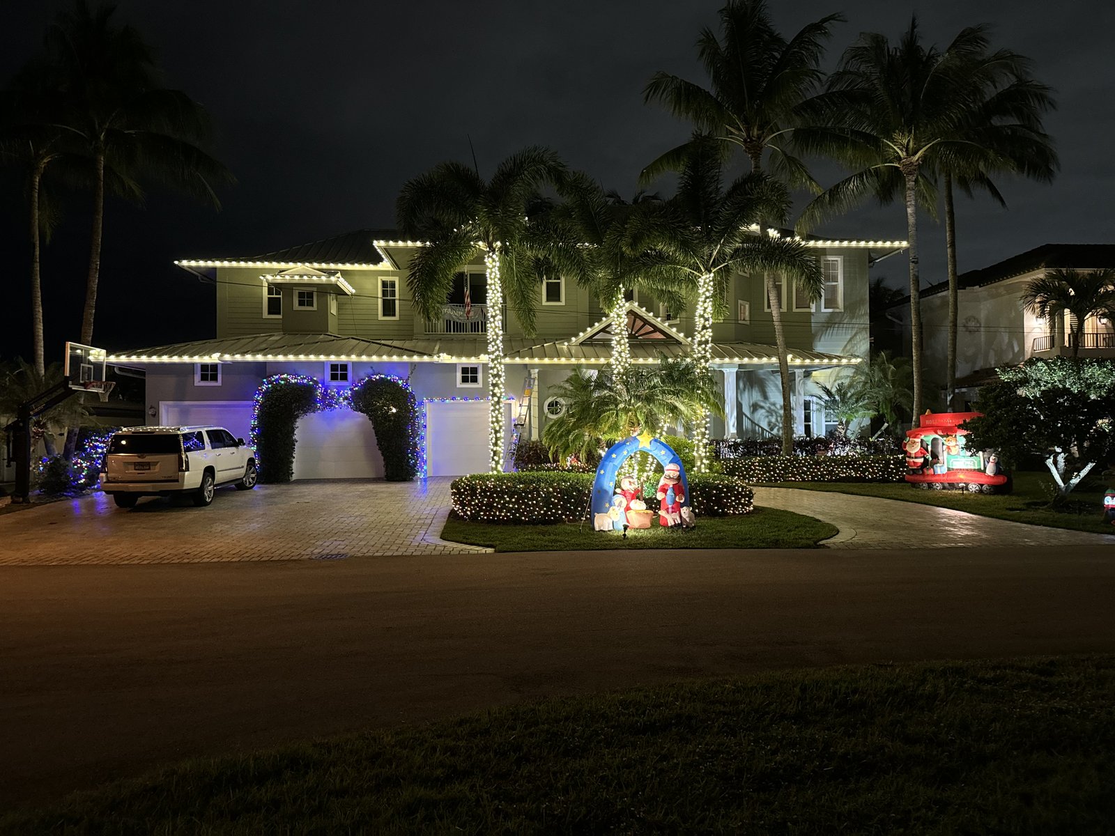 Gulfstream Glow two-story home install with lit palms and nativity scene